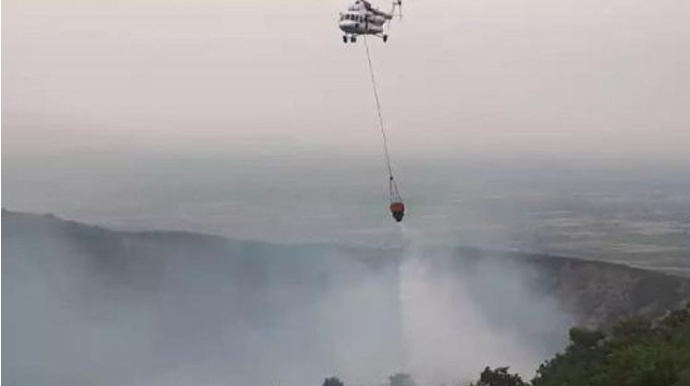 Oğuzda dağlıq ərazidə başlayan yanğının söndürülməsinə helikopter cəlb edilib