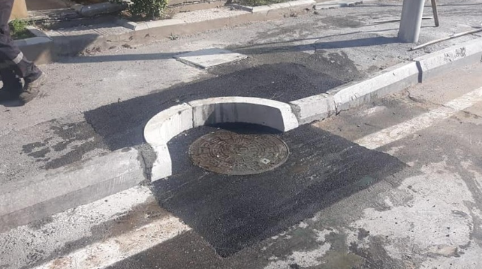 Təhsil Nazirliyinin qarşısındakı çökmüş yol bərpa edilib - FOTO