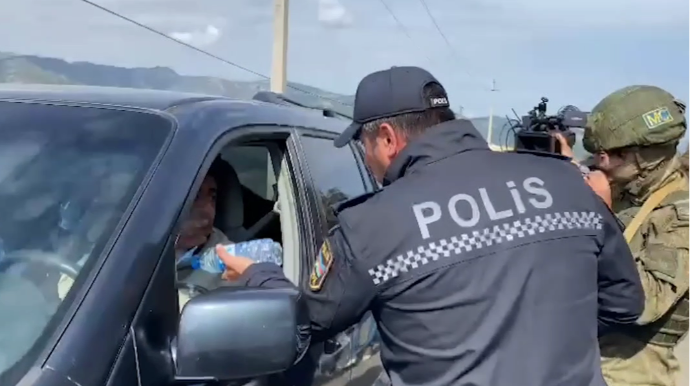 Azərbaycan polisi tıxacda qalan erməniəsilli sakinlərə su paylayıb 