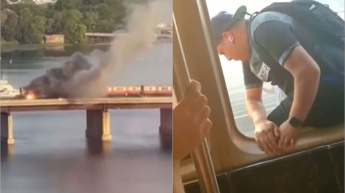 Qatar körpüdən keçərkən yandı: Sərnişinlər pəncərələrdən çıxdı - VİDEO 