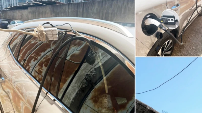 Maşını elektrik ötürücü qüllədən şarja qoyan sürücü GÜNDƏM OLDU - VİDEO 