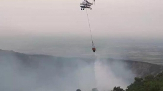 Oğuzda dağlıq ərazidə başlayan yanğının söndürülməsinə helikopter cəlb edilib