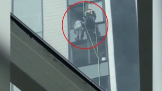 Binanın 20-ci mərtəbəsindən bir saat asılı qalan qız xilas edildi  - VİDEO